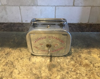Vintage chrome coin bank with key