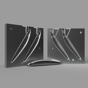 May include: A set of two silver metal molds for making fishing lures. The molds are open and show the shape of the lures. A finished lure is shown in front of the molds.