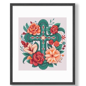 May include: Framed artwork featuring a teal cross adorned with orange and red roses, peach-colored flowers, and green foliage. The cross design is centered, surrounded by floral elements, and set against a light pink background.