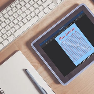 May include: A blue tablet with a white border displaying a light blue sheet of paper with a red handwritten title "Class Schedule". The paper has a grid with columns for days of the week and times of day.