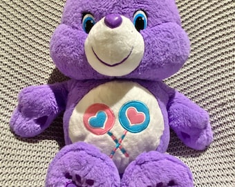 Osito Cariñosito "Share Bear" de Hasbro con piruletas rosas y azules. Tamaño grande: 46 cm.