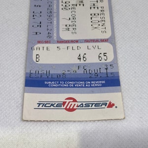 May include: A blue and white ticket for a concert featuring The Recorders at The Block. The ticket is for Gate 5, Field Level, Row 46, Seat 65. The ticket is for August 29th at 7:00 PM. The ticket is subject to conditions on the reverse side.