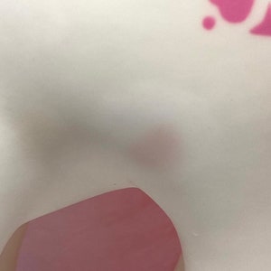 May include: A white ceramic figurine with pink accents. The figurine is shaped like a horse with a long, flowing mane and tail.