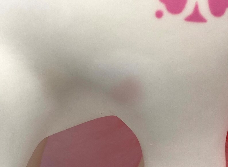 May include: A white ceramic figurine with pink accents. The figurine is shaped like a horse with a long, flowing mane and tail.