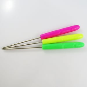 May include: Three metal crochet hooks with colourful plastic handles. The handles are pink, yellow and green.