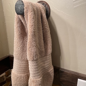 Rail road spike towel holder