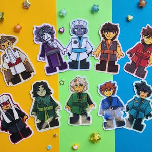 May include: A collection of colorful character stickers, each depicting a unique figure in various outfits. The stickers are arranged on a yellow, green, and blue background, adorned with star and heart-shaped embellishments.