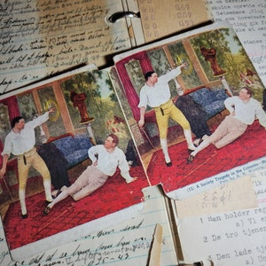 May include: A vintage postcard depicting a scene from a play. The postcard is titled "A Society Tragedy in the Colonies" and features three men in period clothing. The men are standing in a room with a red carpet and a large window. The postcard is in good condition with some wear and tear.