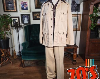 May include: A tan vintage suit, including a jacket with four front pockets and matching pants, displayed on a mannequin. The jacket is paired with a patterned button-down shirt. The image has a retro 70s theme.