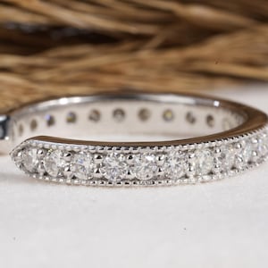 May include: A silver ear cuff with a row of small, clear diamonds set in a delicate band.