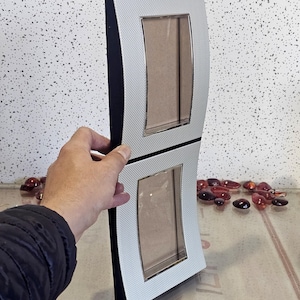 Modern design double folding photo frame, silver plated with a textured finish.