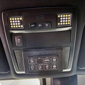 May include: Black car interior panel with LED lights and control buttons. Features an "OFF" button, a "Switch-Pro" control panel with labeled buttons for various vehicle functions, and additional lighting.