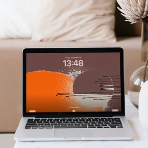 May include: A silver laptop computer with a brown and orange abstract design on the screen. The time is 13:48. The laptop is on a white marble table with a vase of dried flowers and a clear glass cup.