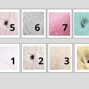 May include: Eight samples of soft, fluffy yarn in various colors, each labeled with a number. Colors include white, light pink, gray, pink, and light yellow. The yarn is tightly wound, showing the texture and fiber of the material.