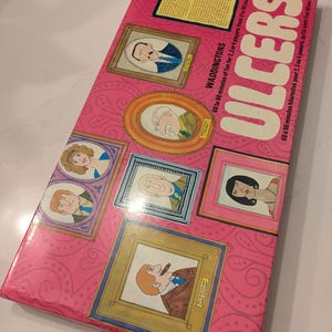 May include: A pink board game box with the title "Ulcers" in white letters. The box features illustrations of people in framed portraits. The game is for 2-4 players and takes 60-90 minutes to play.