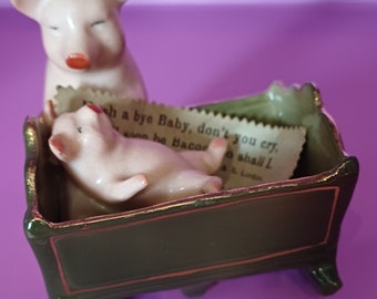 Vintage "Fairing Pig by D.R.G.M. Piglet in cot with original card note, very good