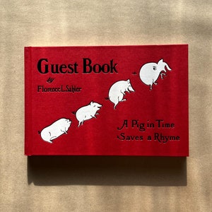 May include: Red hardcover book titled "Guest Book" by Florence L. Sahlier with the subtitle "A Pig in Time Saves a Rhyme". The cover features a series of cartoon pigs in various poses.
