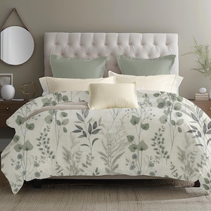 May include: A bed with a cream-colored tufted headboard and a floral patterned comforter. The comforter features a botanical design in shades of green and gray. The bed is made with cream and sage green pillows.