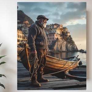 May include: A canvas print depicts a man standing on a wooden dock, holding a rope, with a wooden boat nearby. The man wears a cap, sweater, and pants. A coastal town with colorful buildings is in the background, with the sea and sky visible.