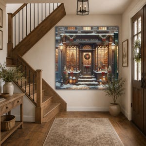 May include: A square wall art print depicting a storefront labeled Old Town Books, decorated for the holidays with snow, wreaths, red bows, and warm glowing lights in the windows, displayed on a wall above a wooden staircase in a home entryway.