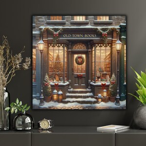 May include: A square wall art print depicting a storefront labeled OLD TOWN BOOKS, featuring a snow-covered entrance, a Christmas wreath on the door, glowing lanterns, decorated evergreen trees, and warm interior lighting visible through the windows.