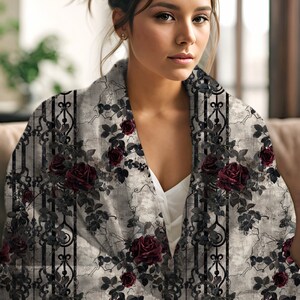 May include: A soft throw blanket featuring a dark floral pattern of deep red roses and black climbing vines set against a distressed light grey background with vertical black stripes and ornate ironwork-style decorative elements.