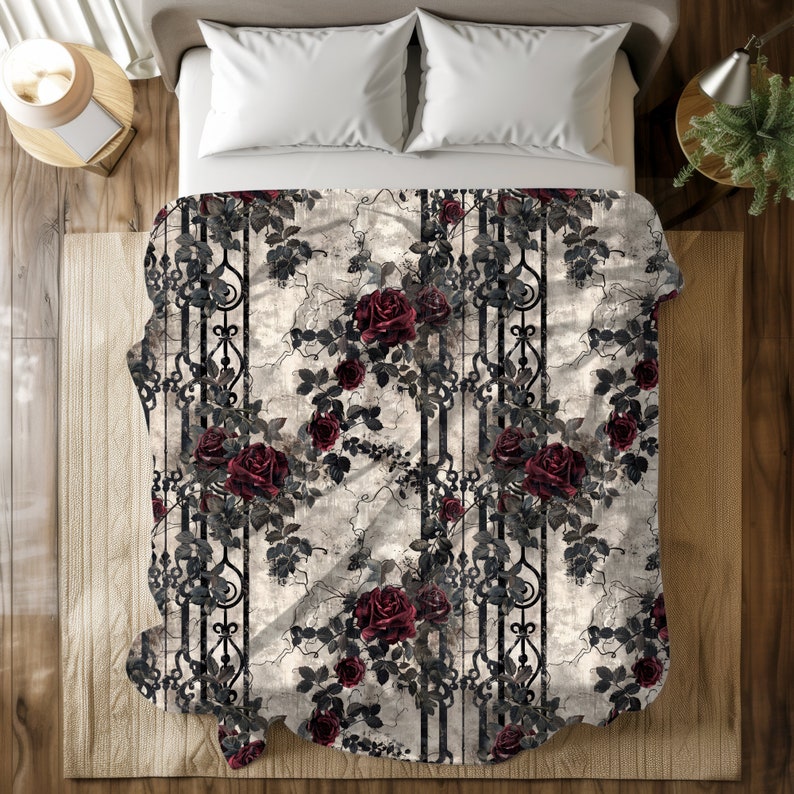 May include: A rectangular throw blanket featuring a repeating pattern of deep red roses and dark green leaves intertwined with black vertical wrought iron-style scrollwork bars against a distressed, light beige and grey textured background.