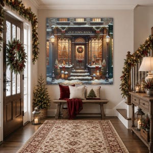 May include: A large square wall art print depicting a snowy storefront labeled OLD TOWN BOOKS, featuring warm interior lighting, holiday wreaths, and lanterns. Below, a wooden bench holds a red velvet pillow and a cream pillow with a tree graphic.