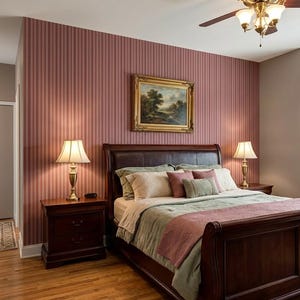 May include: A bedroom featuring a dark wood sleigh bed with a green comforter and a pink throw blanket. Two matching dark wood nightstands hold brass lamps with white shades. A landscape painting in a gold frame hangs on a striped mauve wall.