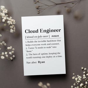 May include: A white card with the text "Cloud Engineer" in a bold, black font. The card includes a definition, pronunciation, and three descriptive points about the profession. The card is surrounded by white flowers and a dark gray background.