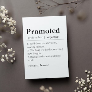 May include: A white card with black text defining the word "Promoted" as an adjective. The definition includes three points: well-deserved elevation, climbing the ladder, and recognized talent and hard work. The card also includes the phonetic pronunciation of the word and the phrase "See also: Jeanne".