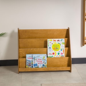 We combine Large Toddler Montessori Bookshelf and Mid Century style Modern Book Shelf Kids Room Montessori Furniture. Here is Wooden Low Nursery Bookcase, Baby Book Box! This large toddler shelf can be best gift from family to new baby boy or girl, toddler or kids. This toddler bookcase will be perfect matches with her or him toddler furniture. Unique design montessori bookcase will be perfect gift as a nursery book shelves and kids room bookcase.