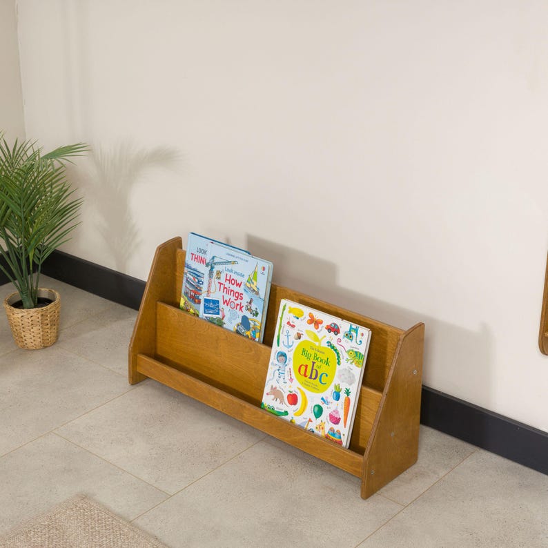 We combine Large Toddler Montessori Bookshelf and Mid Century style Modern Book Shelf Kids Room Montessori Furniture. Here is Wooden Low Nursery Bookcase, Baby Book Box! This large toddler shelf can be best gift from family to new baby boy or girl, toddler or kids. This toddler bookcase will be perfect matches with her or him toddler furniture. Unique design montessori bookcase will be perfect gift as a nursery book shelves and kids room bookcase.