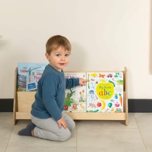 We combine Large Toddler Montessori Bookshelf and Mid Century style Modern Book Shelf Kids Room Montessori Furniture. Here is Wooden Low Nursery Bookcase, Baby Book Box! This large toddler shelf can be best gift from family to new baby boy or girl, toddler or kids. This toddler bookcase will be perfect matches with her or him toddler furniture. Unique design montessori bookcase will be perfect gift as a nursery book shelves and kids room bookcase.