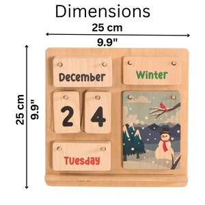 May include: Wooden perpetual calendar with the word "Dimensions" at the top. The calendar is 9.9 inches (25 cm) wide and 9.9 inches (25 cm) tall. It displays "December 24" and "Tuesday" with a winter-themed illustration.