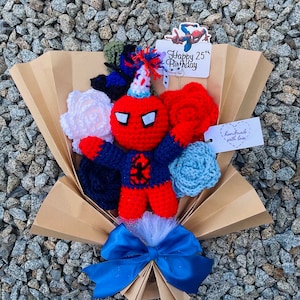May include: A crocheted bouquet featuring a red and blue Spiderman character, white, red, and blue flowers, and a card that says "Happy 25th Birthday".