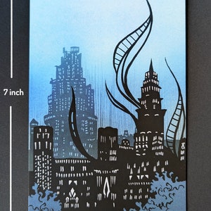 May include: A black and white illustration of a city skyline with tall buildings and a blue sky. The buildings are silhouetted against the sky, and there are some trees in the foreground.