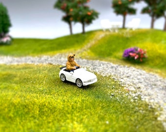 Miniature Boy in Electric Toy Car. 1:64 Scale Human Figure