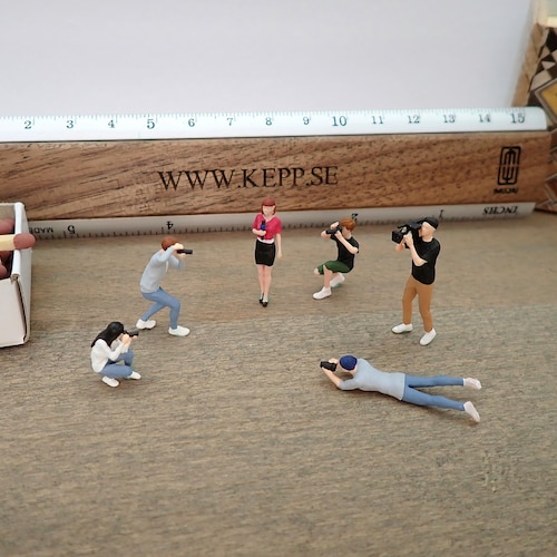 Miniature Human Figures. Photographers, Cameraman and News Anchor
