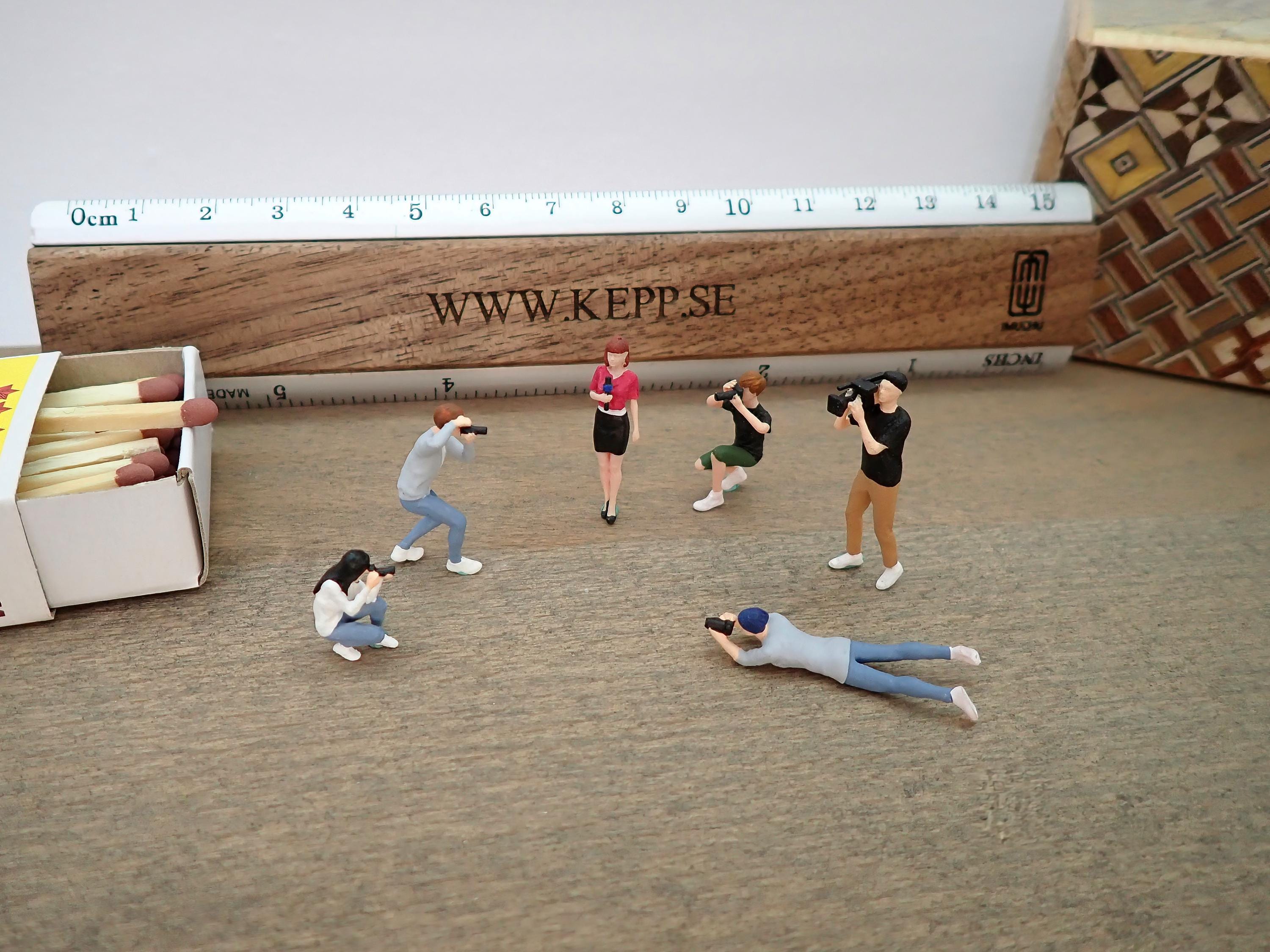 Miniature Human Figures. Photographers, Cameraman and News Anchor