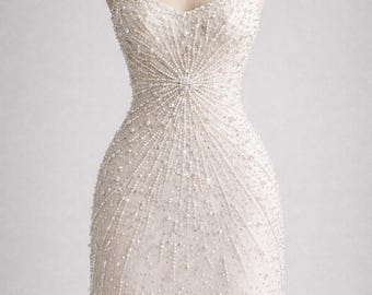 May include: A white, beaded mini dress on a mannequin. The dress features a sweetheart neckline, spaghetti straps, and a fitted bodice that flares out slightly at the waist. The dress is covered in small beads, with a fringe at the hem.