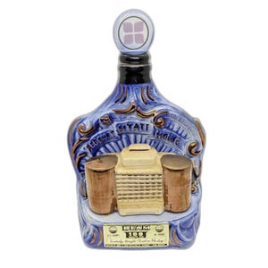 May include: A vintage blue ceramic bottle with a decorative design, featuring the words "Regency Hyatt House." The bottle has a unique shape with a stopper and a label that reads "Beam 100 Months Old Kentucky Straight Bourbon Whiskey."