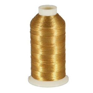 May include: A spool of gold metallic thread for sewing or embroidery.