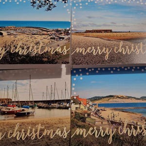 May include: Four rectangular greeting cards featuring coastal landscape photographs. Each card displays a different seaside scene with boats, beaches, and buildings, overlaid with the gold cursive text merry christmas and a white polka dot border.