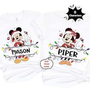 May include: White t-shirts with Mickey and Minnie Mouse dressed as Santa, with the names "Mason" and "Piper". The design includes Christmas lights and ornaments. Ideal for festive family matching during the holiday season.