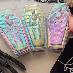thumbnail interactive-video image 1 of Coffin Shape Iridescent Plastic Treat Box – Halloween Favor Container With Skeleton Design, Empty, Clear 1 of 3