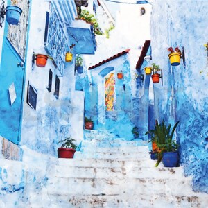May include: A watercolor painting of a narrow, blue-painted street in a city. The street is lined with white buildings and has a set of white stairs leading up to the top of the image. There are potted plants hanging from the walls and on the stairs.