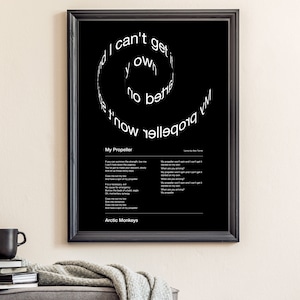 May include: Black framed poster featuring the lyrics to "My Propeller" by Arctic Monkeys. The title is in white, with the lyrics arranged in a spiral. The poster includes the song lyrics and the band's name.