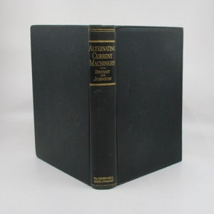 May include: A black hardcover book titled "Alternating Current Machinery" by Bryant and Johnson. The book is published by McGraw-Hill Book Company.