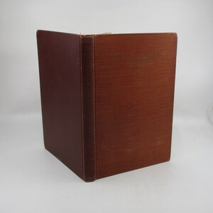 May include: A brown hardback book with the title "The Story of the Grail" and the author "Richard Wagner" on the spine.